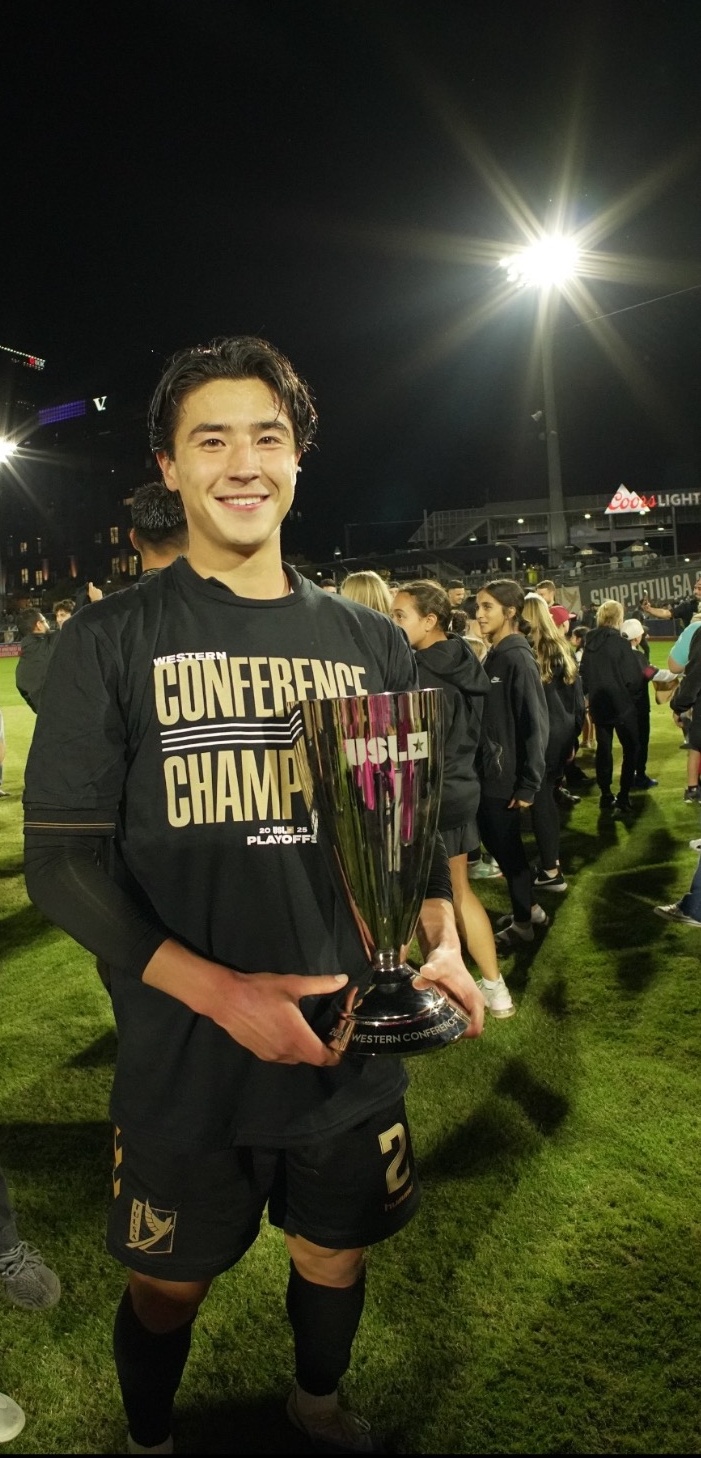 Owen Damm holding a Western Conference Champions trophy